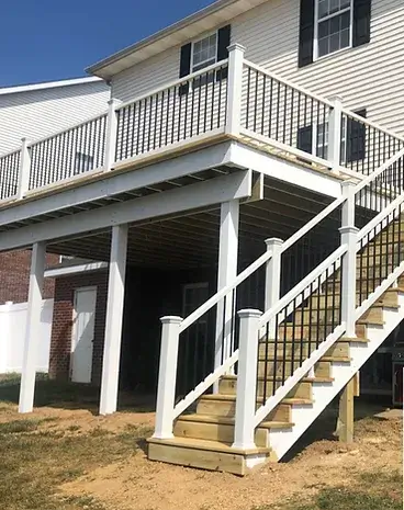 A home with an deck that forms an awning on the ground level. 